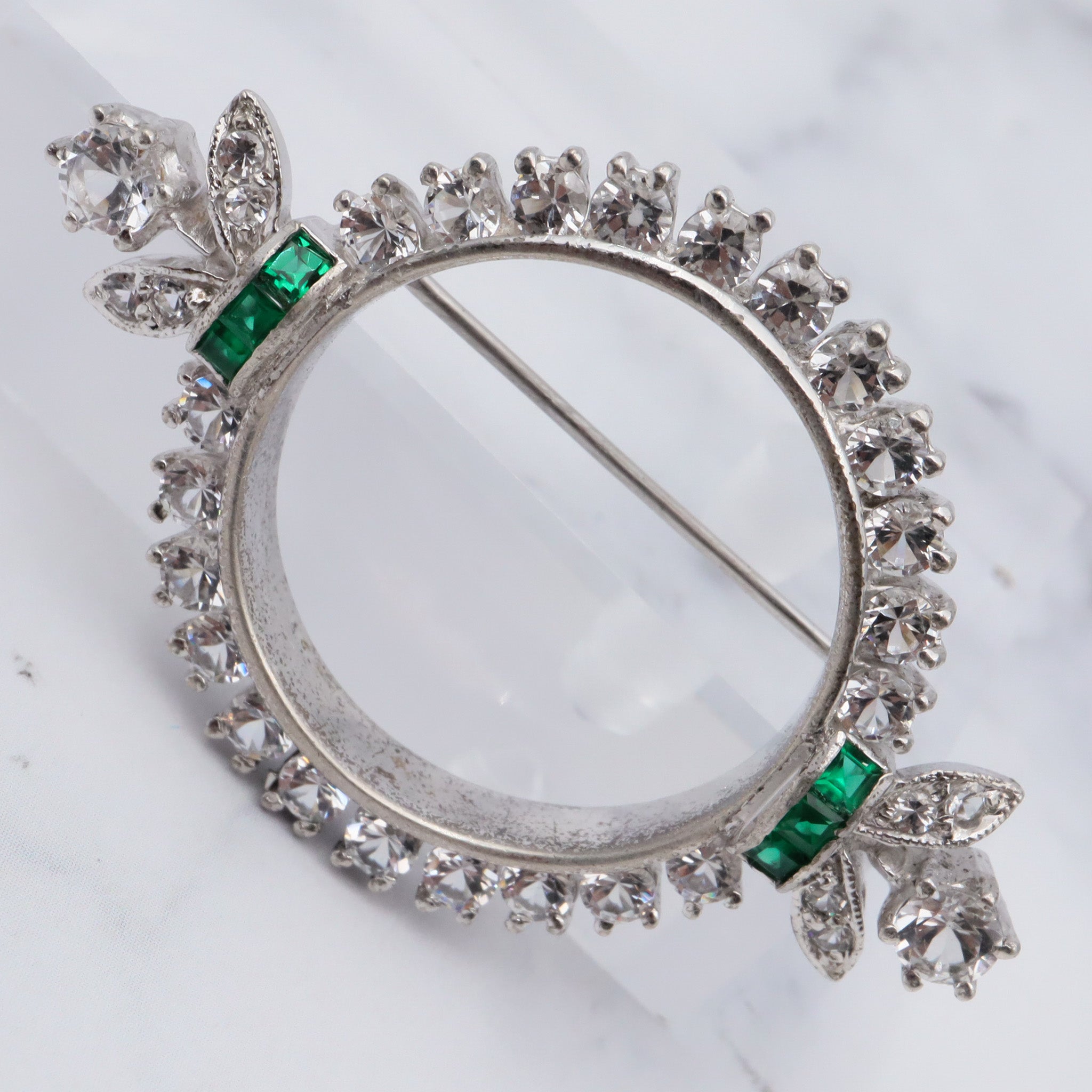 Antique Art Deco rhodium plated sterling, quartz & synthetic emerald circle frame brooch